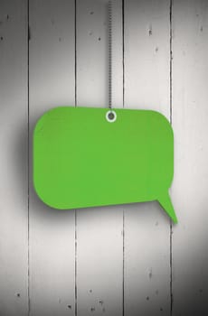 Speech bubble tag hanging against white wood