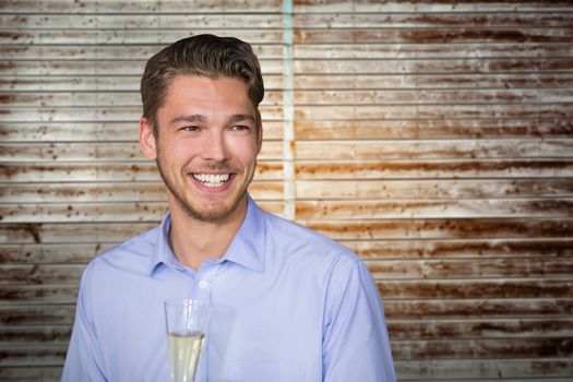 Man toasting with champagne against wooden planks