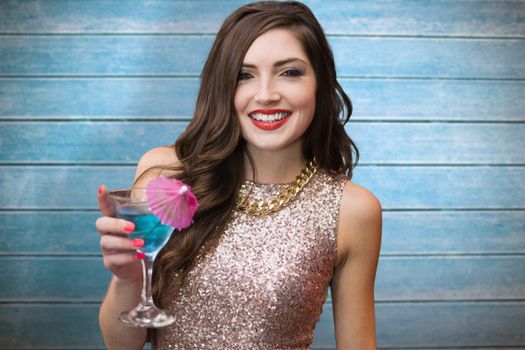 Brunette with cocktail against wooden planks