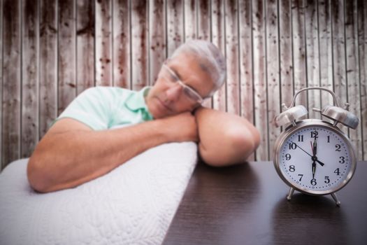 Man napping on couch against wooden planks