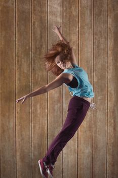 Pretty break dancer against wooden planks background