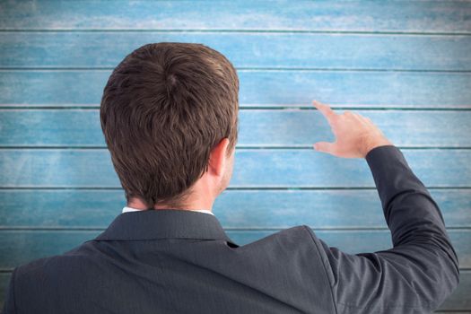 Businessman pointing with his finger against wooden planks