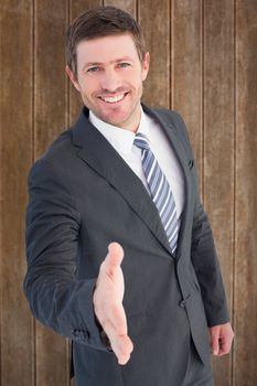 Businessman smiling and offering his hand against wooden planks background