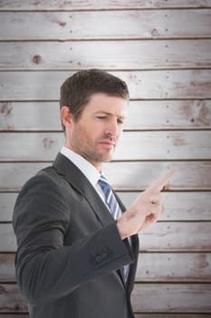 Businessman standing and pointing the finger against wooden planks