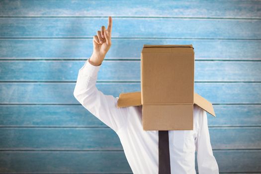 Anonymous businessman with hand pointing up against wooden planks