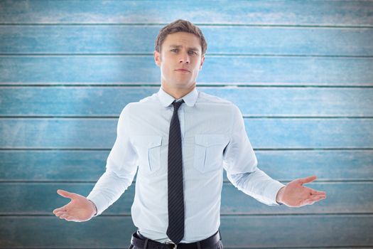 Puzzled businessman against wooden planks