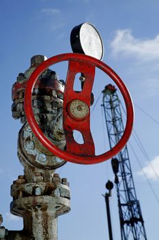 Steel pipeline with red valves against blue sky