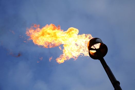 Gas flame torch on a oil refinery plant. Oil industry