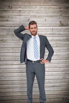 Thinking businessman against wooden planks background