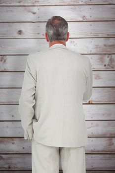 Thinking businessman against wooden planks