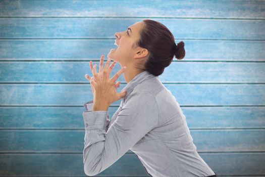 Frustrated businesswoman shouting against wooden planks