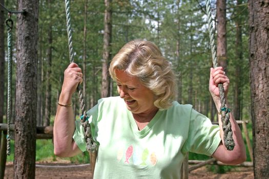 Active Senior Female holding ropes on a course