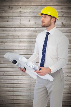 Thoughtful young architect posing against wooden planks background