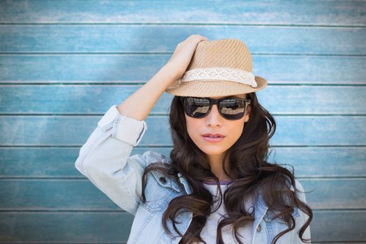 Brunette in sunglasses against wooden planks