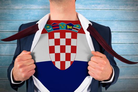 Businessman opening shirt to reveal croatia flag against wooden planks