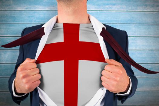 Businessman opening shirt to reveal england flag against wooden planks