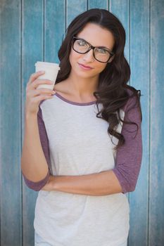 Brunette with mug against wooden planks