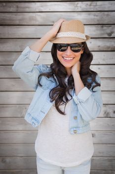 Brunette in sunglasses against wooden planks