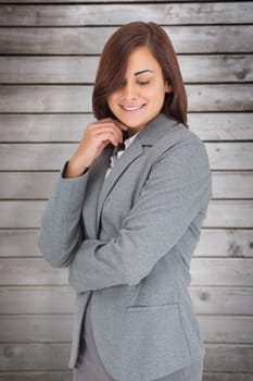 Thoughtful businesswoman against wooden planks