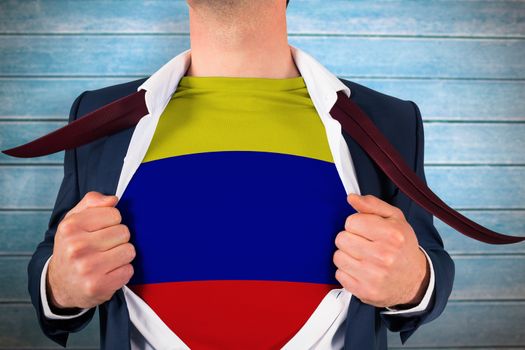 Businessman opening shirt to reveal colombia flag against wooden planks