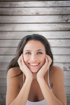 Smiling brunette against wooden planks