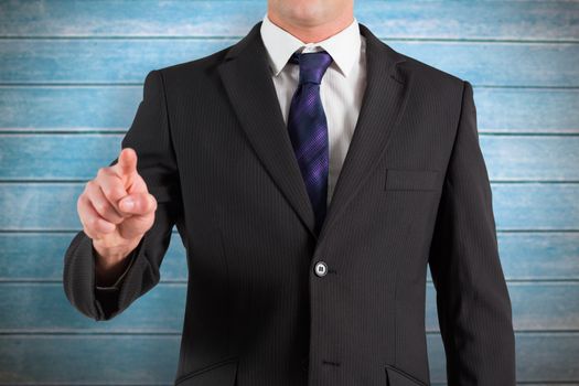 Businessman standing and pointing against wooden planks
