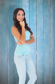 Casual brunette smiling at camera against wooden planks