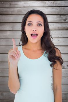 Pretty brunette getting an idea against wooden planks