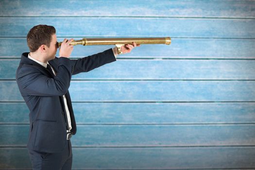 Businessman looking through telescope against wooden planks