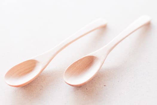 Wooden spoons on brown background, stock photo