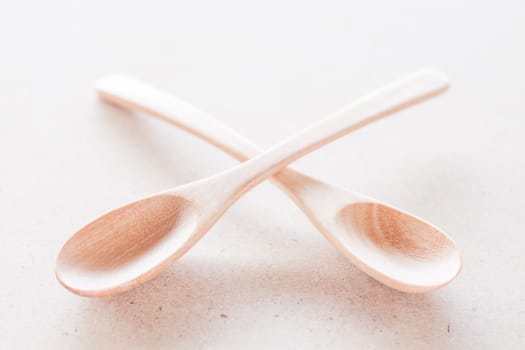 Empty spoons on brown background, stock photo