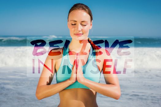 Fit woman meditating on the beach against believe in myself