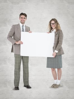 Hipster couple holding poster smiling at camera against white background