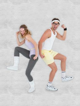 Geeky hipster couple posing in sportswear against white background