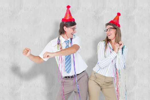 Happy geeky couple dancing  against white background