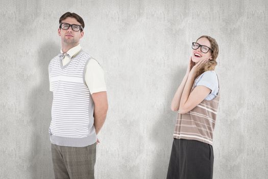 Geeky hipster couple looking at camera  against white background