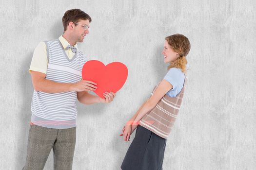 Geeky hipster giving heart card to his girlfriend  against white background