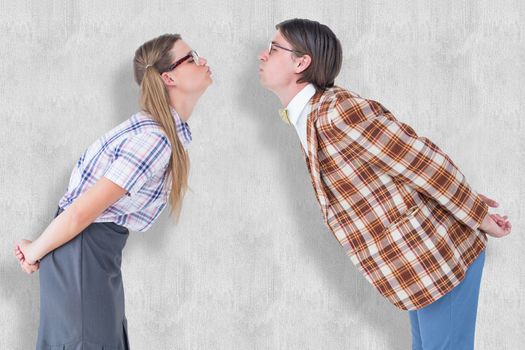 Geeky hipster couple kissing against white background