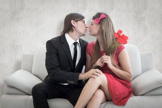 Cute geeky couple kissing against white background