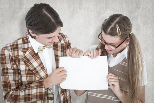 Geeky hipsters holding a poster  against white background