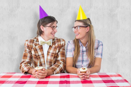 Geeky hipsters celebrating birthday  against white background