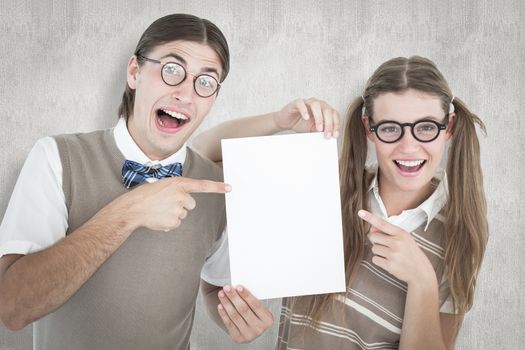 Geeky hipsters pointing at poster  against white background