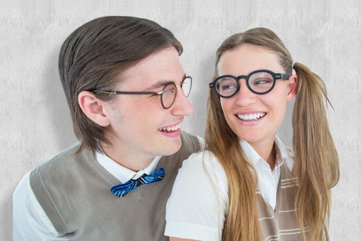 Geeky hipster couple smiling at each other against white background