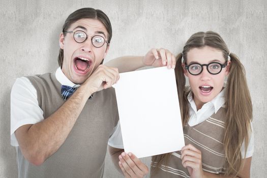 Geeky hipsters holding a poster  against white background