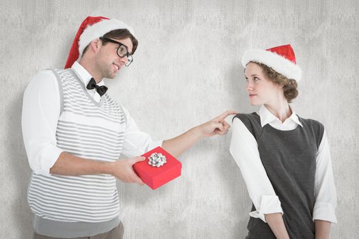 Geeky hipster offering present to his girlfriend against white background