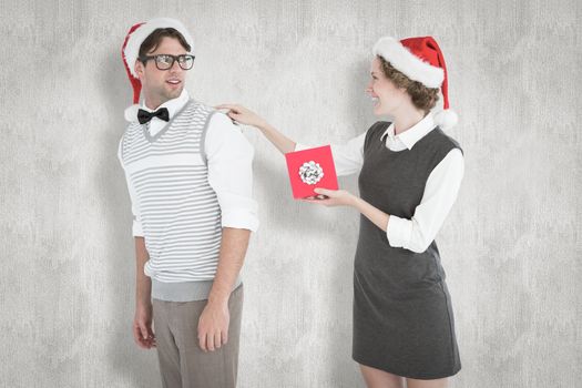 Geeky hipster offering present to her boyfriend against white background