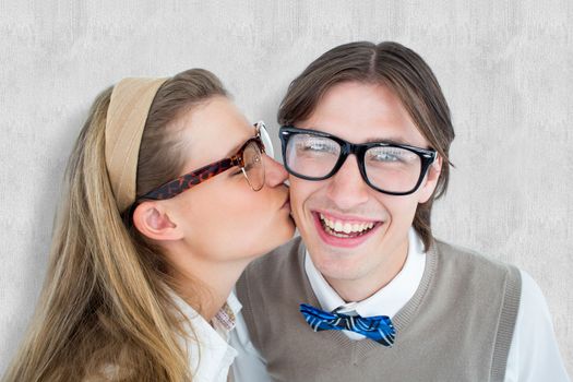 Geeky hipster kissing her boyfriend  against white background