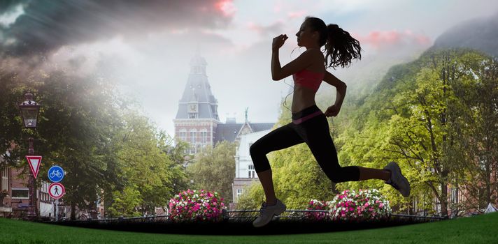 Full length of healthy woman jogging  against sun shining over park