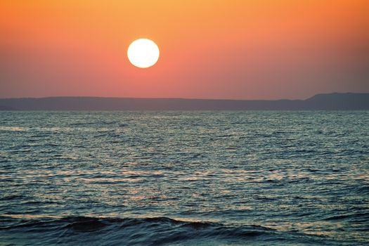 Sunset at sea off the coast of the Mediterranean sea.