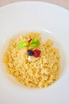 Millet porridge with berry closeup